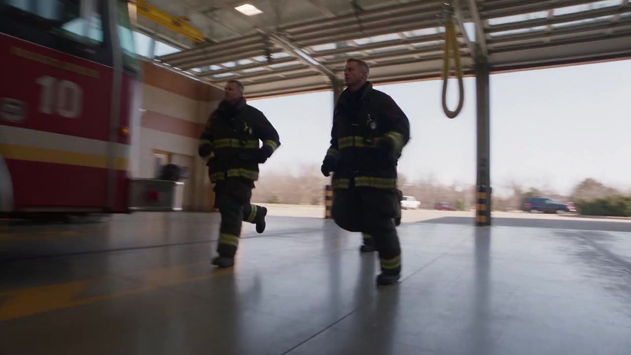 Firefighters preparing to board their engine